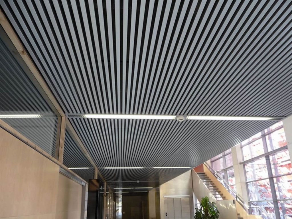 This is a white false ceiling composed of strip ceiling.